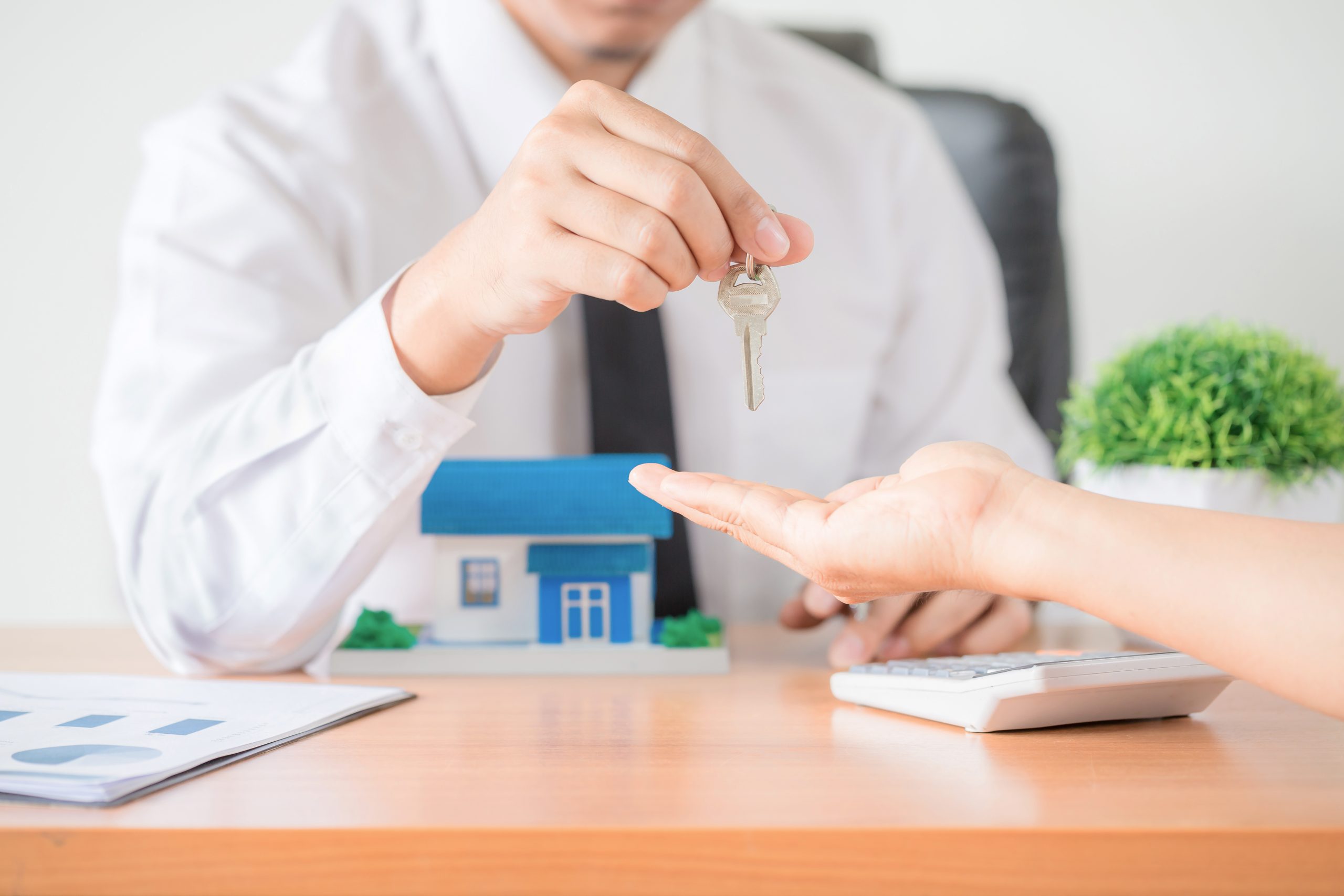 Realtor agent giving a key of apartment to new owner Home Villa Purchase